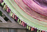 A close up photo of a textured shawl with fringe, featuring the colours of the BC Orchards Bite-Size Mini Set.