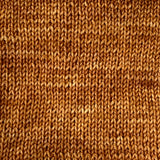 close up of a knit swatch in a rich golden brown colour